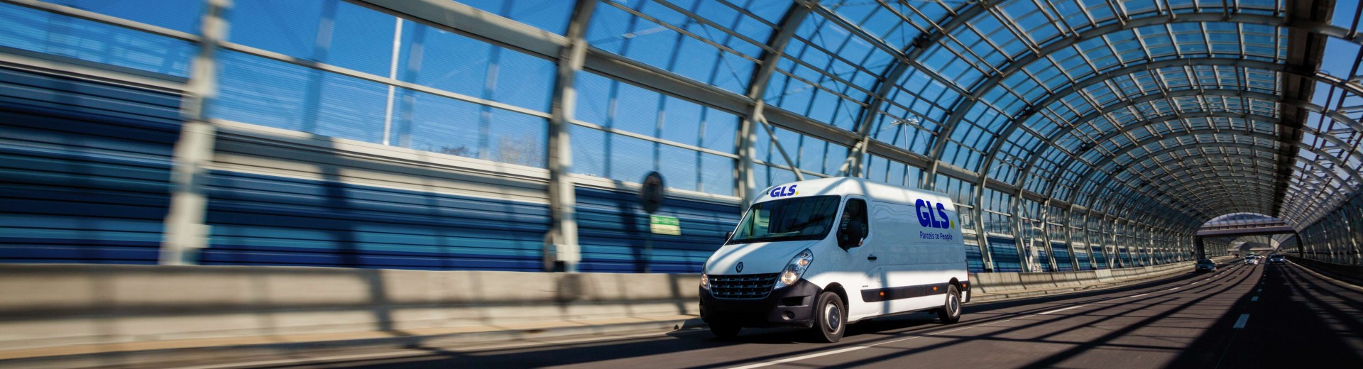 Van driving through a glass tunnel