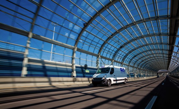 Van driving through a glass tunnel