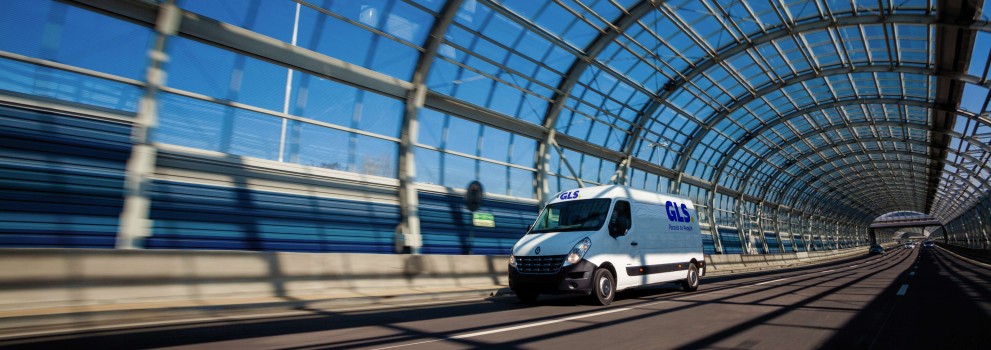 Van driving through a glass tunnel