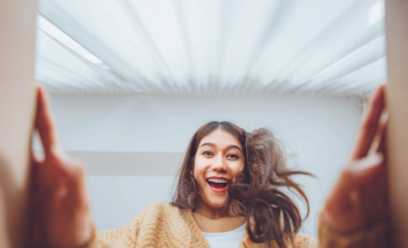 The girl opens a parcel from the courier