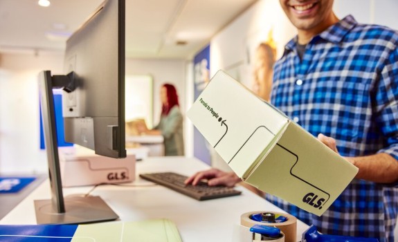 Man coming out from a GLS parcel shop