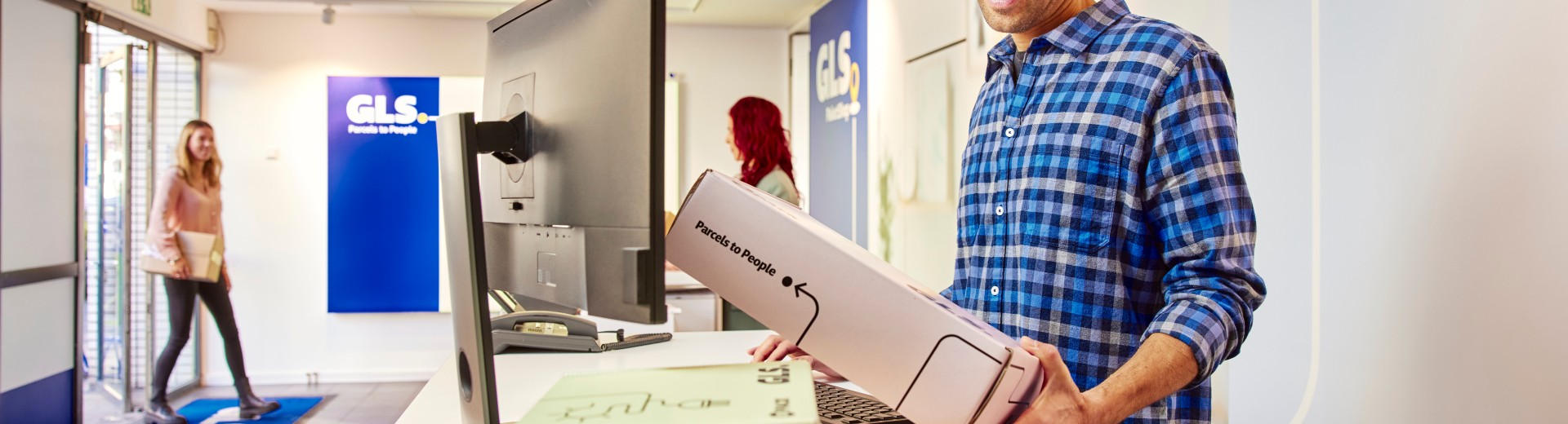 Man coming out from a GLS parcel shop